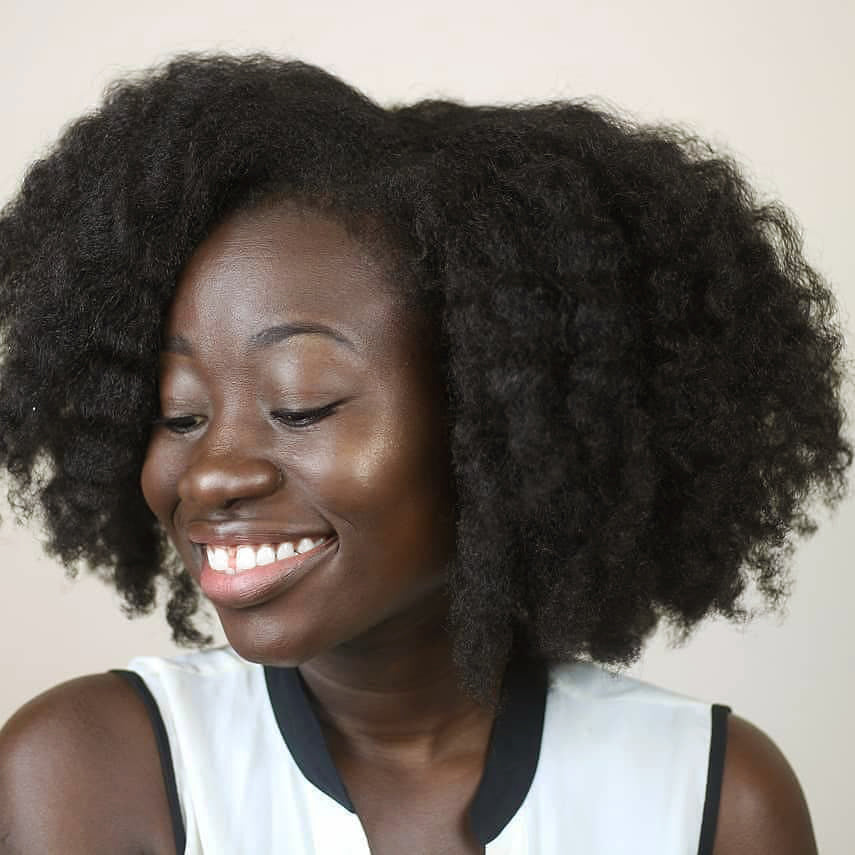 Woman showing off her long 4C stretched out twist out after styling with the moisture burst system